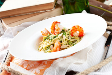 Shrimp pasta. On a wooden table.