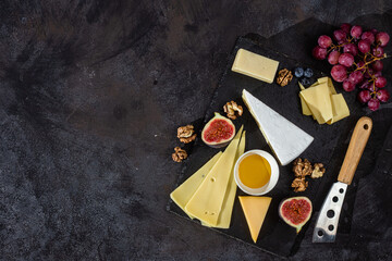 Different cheeses on a plate with honey