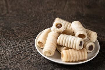 Los huesos de santo on white plate., Spanish marzipan pastry served  for All Saints Day.