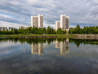 Fototapeta na wymiar Pedestrian bridge over the pond in Zelenograd Moscow, Russia