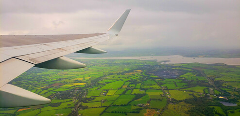 airplane wing over pastures © Andrea