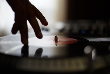 Hand of dj playing vinyl records on turntable. Analog hi fi audio equipment