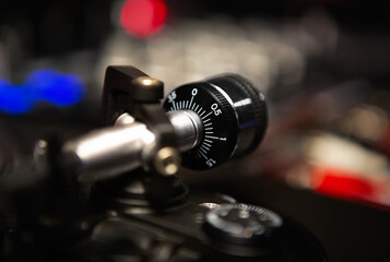 Fototapeta na wymiar DJ turntables tonearm weights in close up. Professional audio equipment for disc jockey