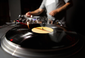 Hip Hop dj plays music with vinyl turntables. Professional disc jockey mixing musical tracks on...