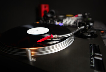 Turntables needle on a record. Retro dj turn table player device plays vinyl disc with music....