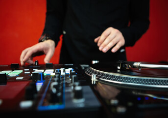 Hip hop dj scratches vinyl records on turntables. Disc jockey mixing musical tracks with sound...