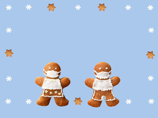 Cute gingerbread couple with protective face masks in a frame from snowflakes and stars. Original greeting card in coronavirus (COVID-19) time, isolated on blue background, copy space for text