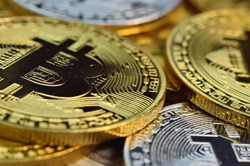 golden and silver bitcoin coins.