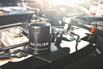 New oil filter of the car for engine oil system maintenance in the repair garage - obrazy, fototapety, plakaty