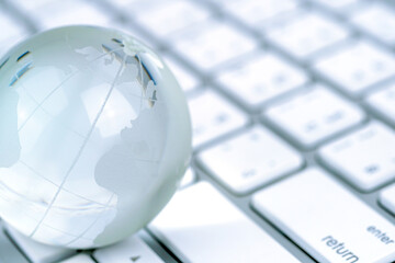 Glass globe and the keyboard, world business and economy.	
