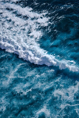 Aerial view to seething waves with foam. Waves of the sea meet each other during high tide and low tide - 460872979