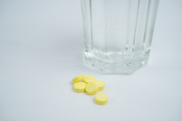 Medical pills and glass whit water on white background