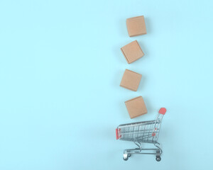 Toy shopping cart with boxes shopping and delivery concept