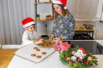 Mother and son with a cookies fresh from the oven at Christmas