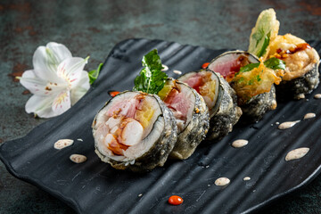 tempura sushii on the black plate