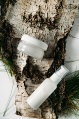 Natural cosmetic bottles on a light background