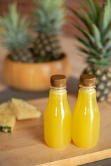 Bottle of of pineapple on the wooden cutting board. Pineapple is a tropical fruit healthy and very juicy. They have sweet and sour taste. Pineapple is from South America now is the world famous fruit.