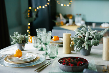 Table served for Christmas dinner in living room, close-up view, table setting, Christmas decoration.