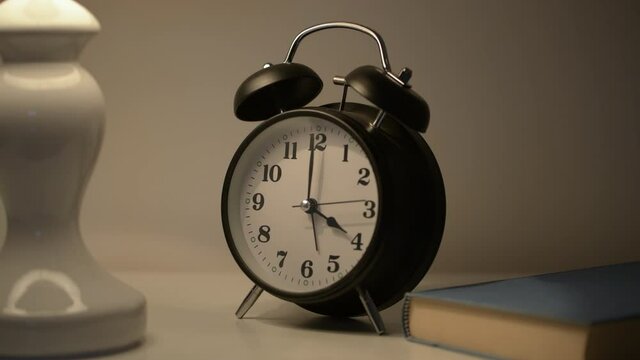 Bedroom bedside lamp and clock at 4 o'clock in the morning for insomnia concept
