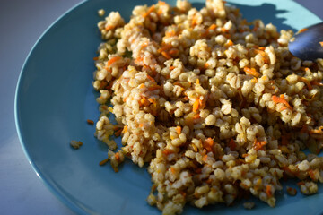 Boiled pearl barley with spices on a plate
