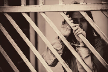 Portrait of women desperate to catch the iron prison,prisoner concept,thailand people,Hope to be...