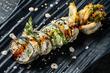 tempura sushii on the black plate