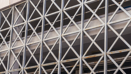 Car parking building with metal grille. Abstract steel surface with copy space. Urban concept.