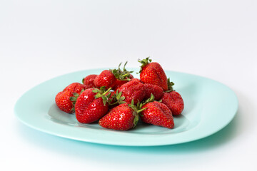 Delicious red strawberries, isolated on a plate. Background texture.