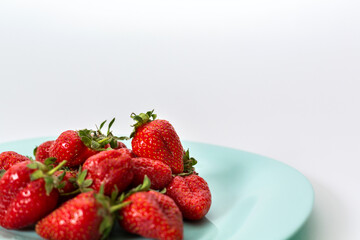 Delicious red strawberries, isolated on a plate. Background texture.