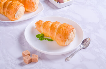 Puff pastry tube filled with protein cream on a plate