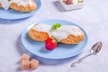 Choux pastry filled with cream and glazed on a plate