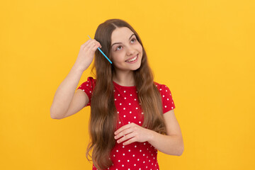 portrait of frizz child. haircare and hair loss. female fashion model. smiling kid combing hair.