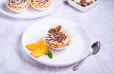 Tartlet cake filled with fruit cream with chocolate sprinkles on a plate