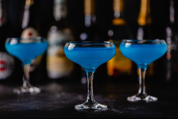 Blue cocktail / wine / champagne on a dark table