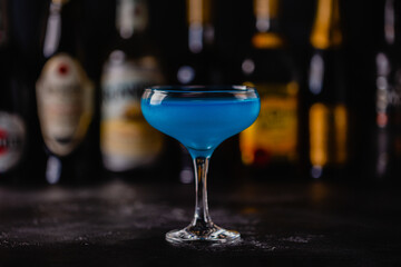 Blue cocktail / wine / champagne on a dark table