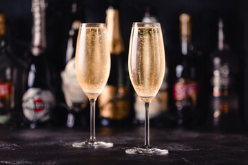 Champagne glasses on a dark background.