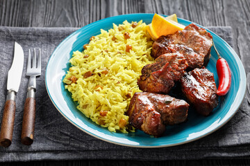 roasted meat served with raisins saffron rice