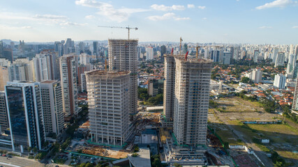 Naklejka na ściany i meble Aerial drone view of the Brooklin neighborhood in São Paulo, Brazil. Four tall buildings under construction