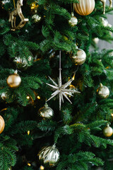 Christmas tree toy star on the tree close-up. New year greeting card