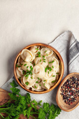 Homemade meat dumplings with onions and parsley- russian pelmeni. Top view