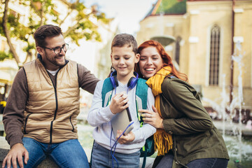 Young parents taking their little child to school