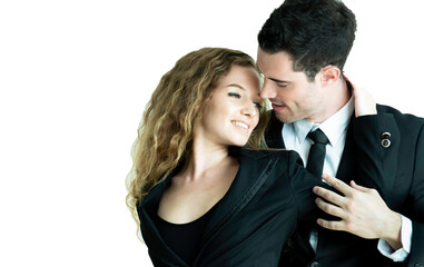 Happy couple wearing suit smiling and embracing each other while looking at each other isolated against white. Professional successful couple embracing together. Relationships and people concept.