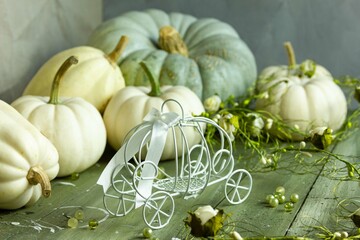vegetables on a table, Cinderella Pumpkin carriage on a green wooden background,  bright pumpkins,...