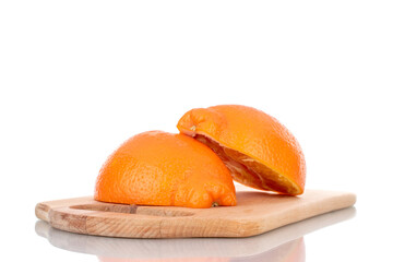 Two halves of organic ripe minneola on a wooden board, close-up, isolated on white.