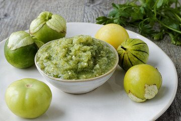 Fresh tomatillo green salsa (salsa verde cruda) in a bowl. Typical Mexican cuisine.