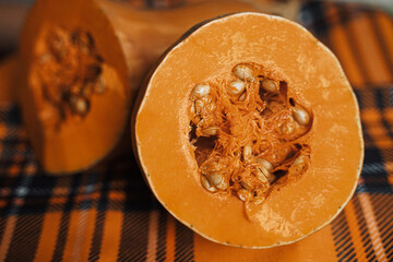 the pumpkin in the cut lies on an orange plaid