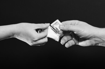 The drug dealer passes the white powder to the customer, the illicit distribution of the drug.