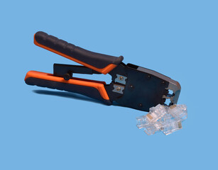 Naklejka premium Ethernet crimping tool and RJ45 connectors on blue background.