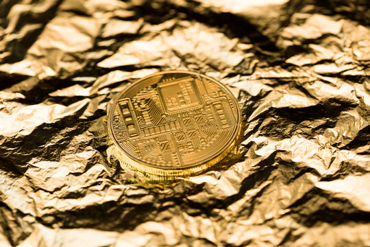 Crypto coin on gold leaf