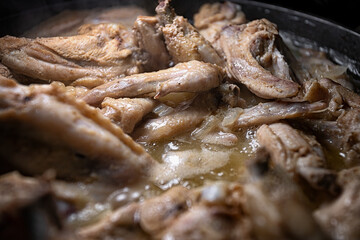 Chicken wings are cooked in their own juice in a pan